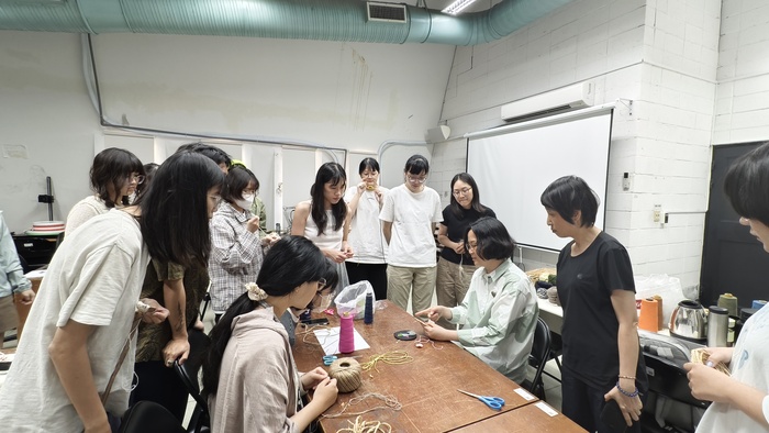 吳佩珊老師在「天然纖 維探索」工作坊示範纏 繞編籃的製作方式。 (拍攝:林建志)